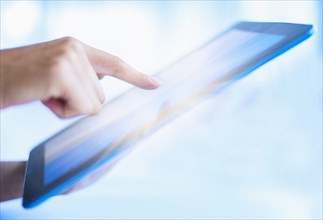 Hispanic woman using digital tablet