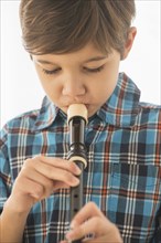 Hispanic boy practicing recorder