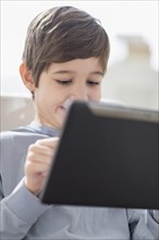 Hispanic boy using digital tablet
