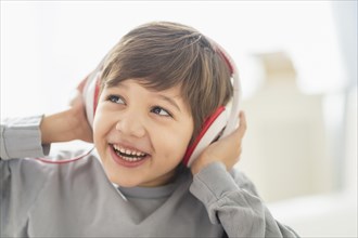 Hispanic boy listening to headphones