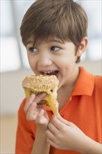 Hispanic boy eating muffin