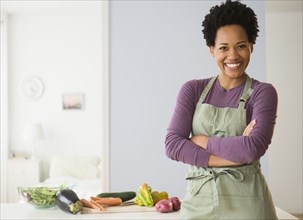 Portrait of black woman cooking in kitchen