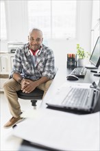 Black businessman smiling at desk