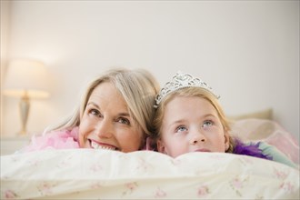 Senior Caucasian woman and granddaughter playing dress up