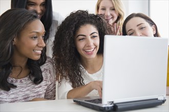 Women using laptop together