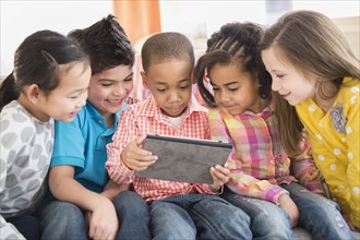 Children using digital tablet together