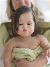 Hispanic toddler making faces after bath