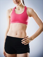 Caucasian woman with bare stomach wearing sports clothing