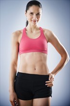 Caucasian woman with bare stomach wearing sports clothing