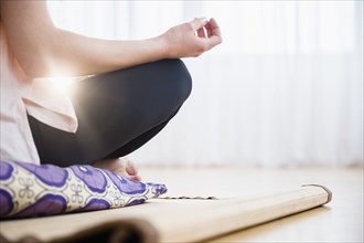 Caucasian woman meditating on yoga mat