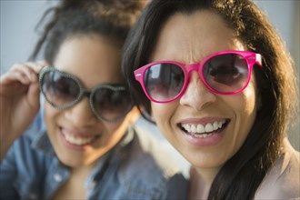 Mother and daughter wearing novelty sunglasses