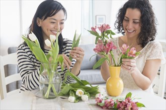 Women arranging flowers together