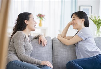 Women talking on sofa