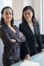 Businesswomen smiling together in office