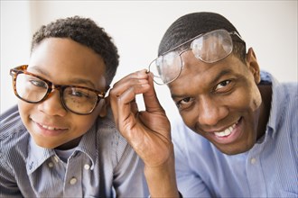 Father and son wearing glasses together