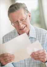 Senior Caucasian man reading letter