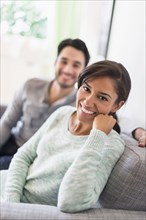 Couple relaxing together on sofa