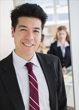 Mixed race businessman smiling in office