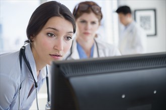 Doctors using computer in office