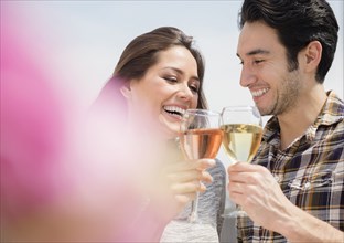Couple toasting each other with wine