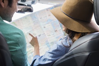 Couple reading map together
