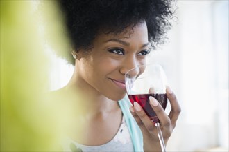 African American woman drinking glass of wine