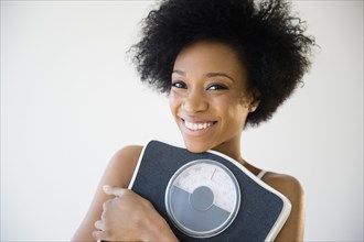 African American woman holding scale