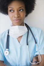 African American nurse wearing stethoscope and surgical mask