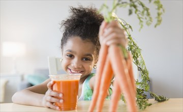 African American girl drinking carrot juice