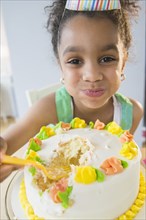 African American girl eating birthday cake