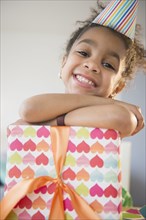 African American girl holding wrapped birthday gift