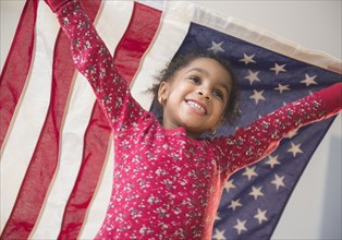 African American girl playing with United States flag