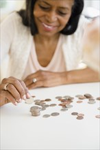 Mixed race woman counting change