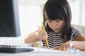 Filipino girl drawing at computer