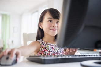 Filipino girl using computer at desk