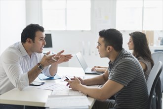 Hispanic business people working together in office