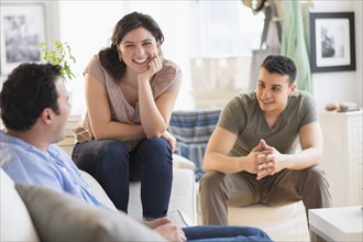 Hispanic friends talking in living room