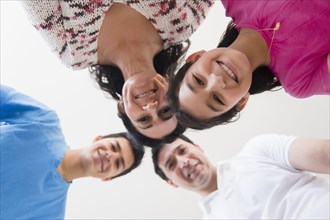 Low angle view of Hispanic family smiling