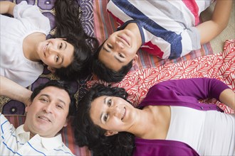 Hispanic family laying together on blankets