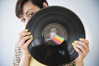 Mixed race woman holding vinyl record