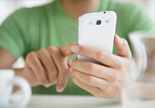 Close up of mixed race man using cell phone