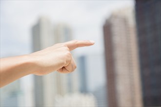 Close up of mixed race man pointing to city skyline
