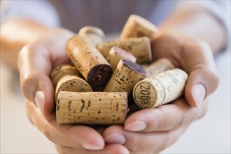 Close up of mixed race man holding wine corks