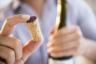 Close up of mixed race man holding wine cork