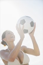 Caucasian woman holding soccer ball outdoors