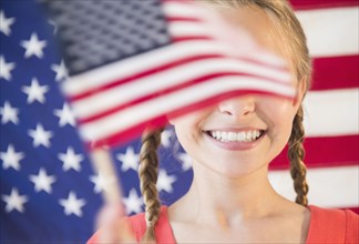Caucasian girl waving American flag