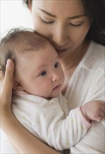 Asian mother holding baby