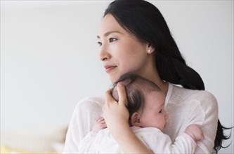 Asian mother holding baby