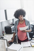 Pregnant African American businesswoman working in office