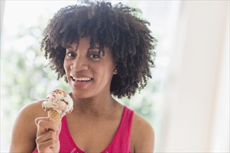 African American woman eating ice cream cone